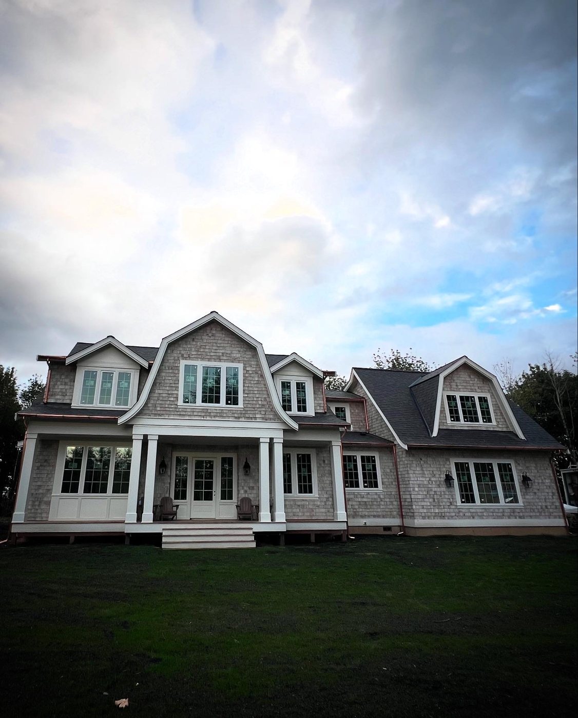 Custom cedar-shake home with white trim and copper gutters built out by O'Neil Custom Exteriors