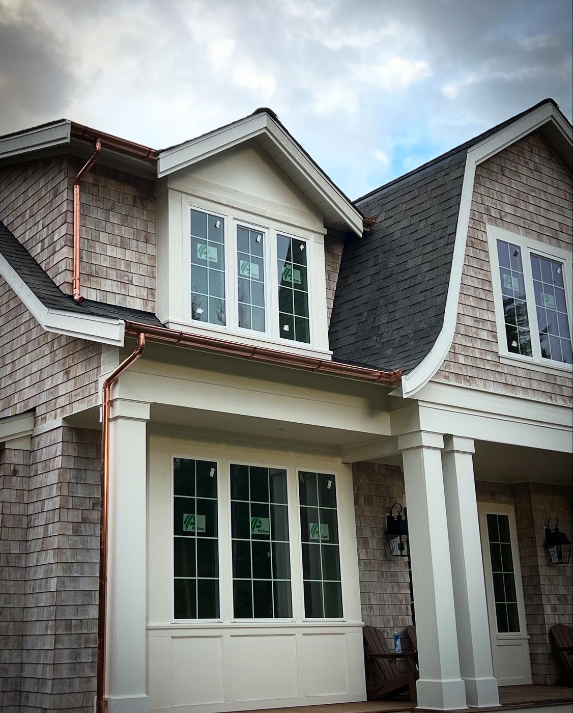 Front porch with square columns, wainscot panels and divided-light windows
